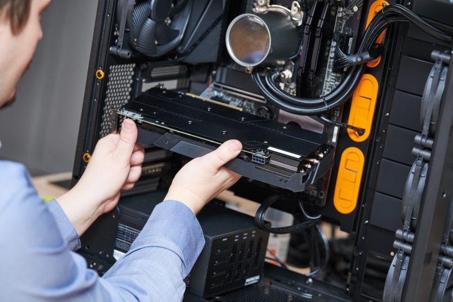 Computer assembling or repair service. repairman installing graphic card during maintenance or upgrade